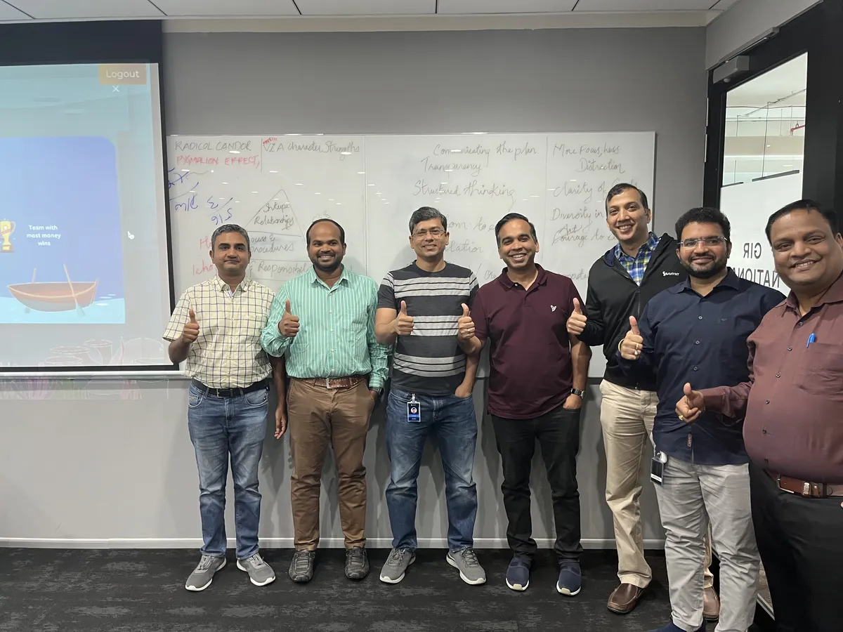 Team group photo with thumbs up