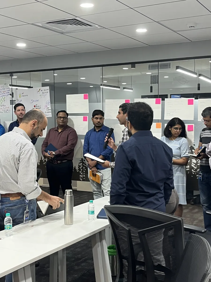 Standing group discussion with whiteboards