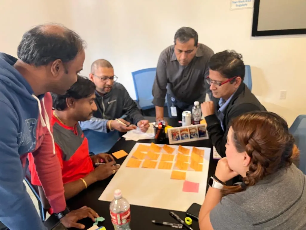 Small group coaching discussion with cards